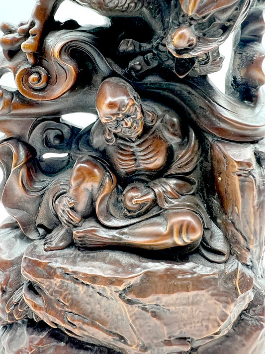 The wood carving of Arhat subduing the dragon